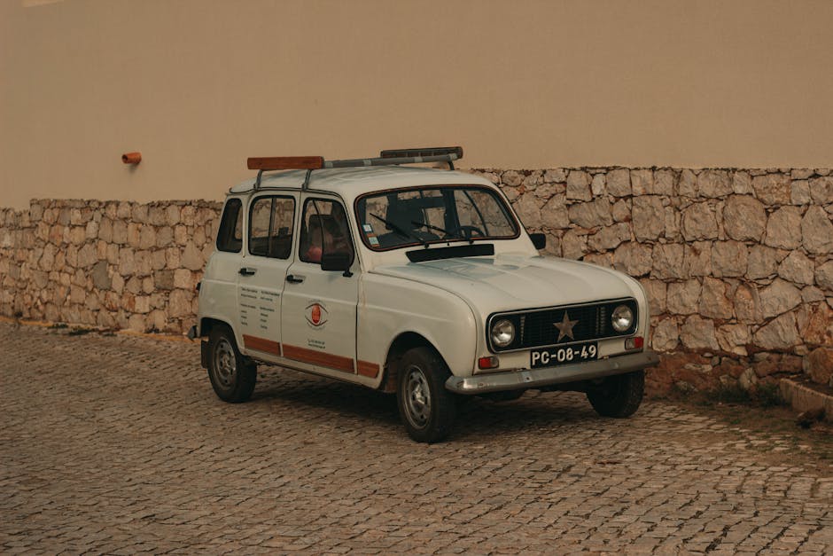 Vintage classic white car against a stone wall